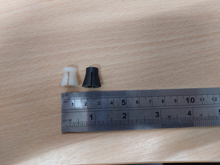 3D Printed Isolator Inserts (black) with the Original Inserts (white) - Smaller Isolator Version